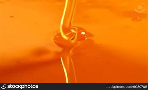Close up of pouring honey on honey