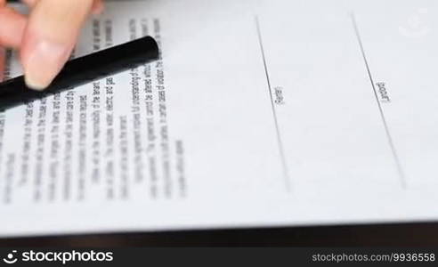 Closeup of businessman showing his new business partner where to sign a rental agreement or contract with a fountain pen, and renter and landlord signing the rental contract. Depth of field.