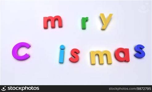 Colorful letter falling down on neutral background to compose "Merry Christmas"