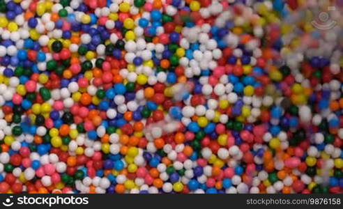 Colorful sprinkles sugar candy pouring down