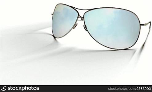 Computer generated animation of static sunglasses on a white surface reflecting moving clouds on a blue sky. High definition 1080p.