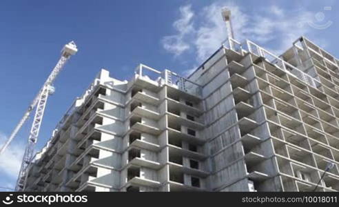 Construction of building. Beautiful sky background. Time lapse with running clouds.