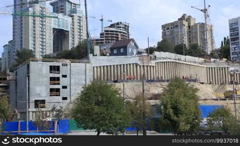 Construction site with crane and building over cityscape background in daylight