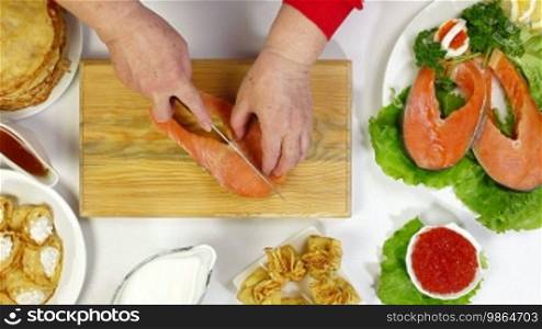 Cooking pancakes with salmon - cutting a steak