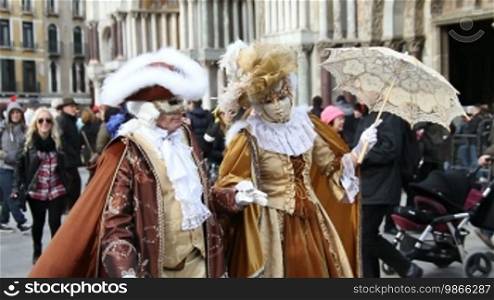 Couple in Rococo costumes on St. Mark's Square, in Venice.