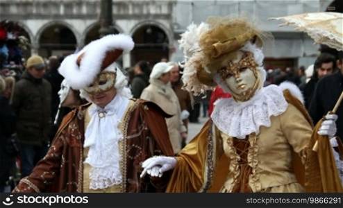 Couple in Rococo costumes on St. Mark's Square in Venice.