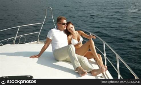 Couple relaxing on the deck of luxury yacht