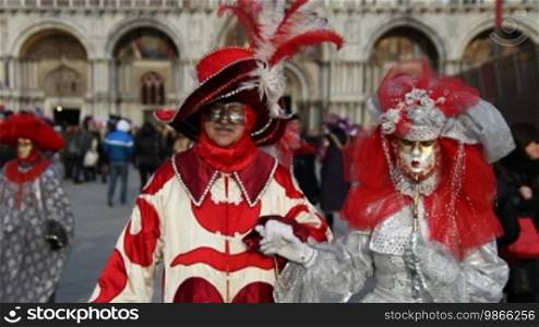 Couple with fantasy masks in Venice