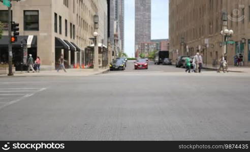 Crowded Chicago city center of vehicles and pedestrians. Golden Mile life on a weekday at Michigan Avenue downtown district. Lots of cars and commuters in Illinois. Human activity on the streets of Chicago.