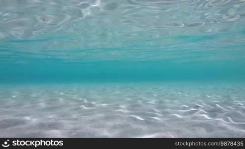 Crystal clear sea water in Sardinia, Italy. Underwater view of the Italian coast in Sardinia, Italy on the Mediterranean Sea. No people, copy space