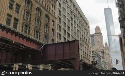 Cta trains running on elevated tracks of Metro Chicago. Commuters traveling by train to their offices in the financial district of Illinois in the United States of America. Subway running through the center of the city in the downtown district.