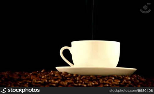 Cup of hot fresh coffee on beans