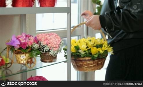 Customer purchasing flower arrangement in florist shop