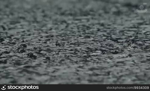 Dense rain pours pavement