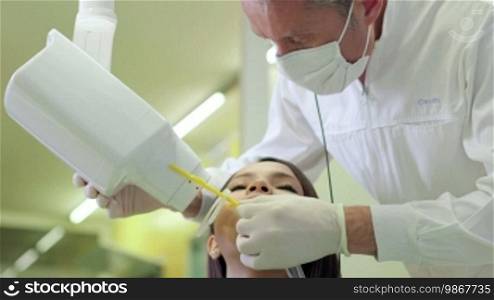 Dentist visiting young Asian woman in dental studio, people and oral hygiene, health care in clinic, x-ray machine. 13 of 19