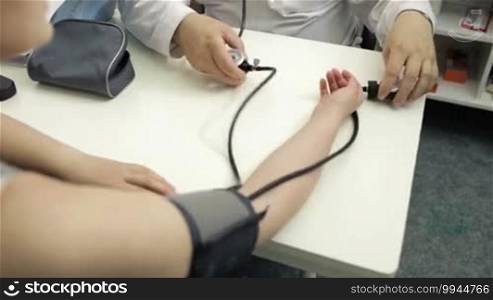 Doctor measures the blood pressure