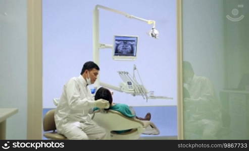 Doctor visiting young woman in dentist studio, people and oral hygiene, health care in hospital, x-rays on computer screen. 11 of 19