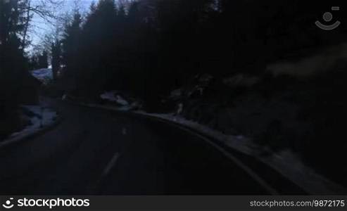 Drive over an ascending mountain pass road in Switzerland