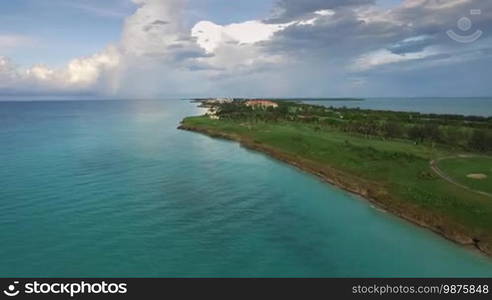 Drone flying over Varadero, Cuba. Aerial view of Cuban tropical beaches. Landscape seen from the sky with clouds and ocean. Travel destination for tourism, holidays and vacations.