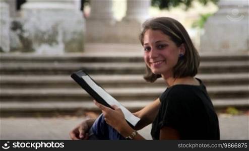 Education and university students, portrait of a happy female student smiling at the camera while drawing and sketching for art school. Sequence