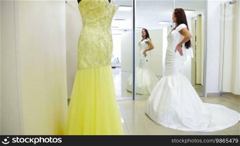Elegant Bride Trying On Wedding Dress in Bridal Boutique