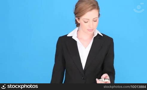 Excited Businesswoman Using Mobile Phone with her fist and teeth clenched in anticipation of good news.