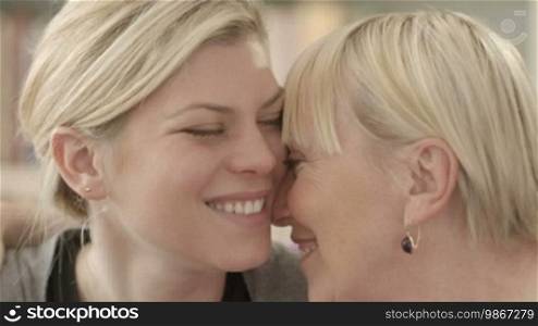 Family portrait of happy mom and daughter smiling, hugging, showing love and affection. Close-up, slow motion