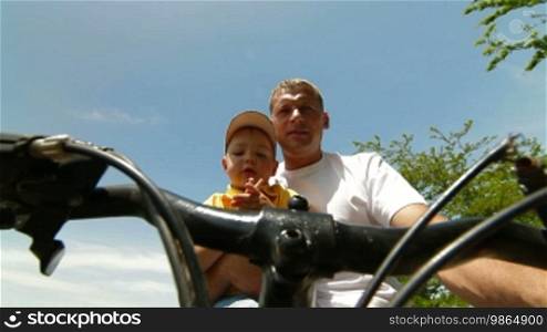 Father with toddler riding the bike