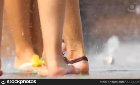 Feet splashing in the fountain