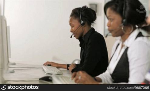 Female call center representatives talking on the phone