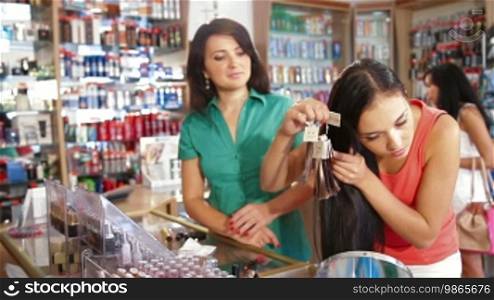 Female Customer Choosing Tone of Hair Dye in Beauty Department