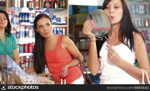 Female Friends Testing and Buying Cosmetics in Beauty Department