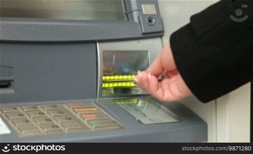 Female Hand Withdrawing Money From ATM Machine