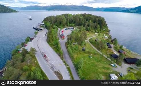 Ferries cross. Aerial footage of Beautiful Nature in Norway. Flying over the lakes and fjords. View from a bird's-eye view.