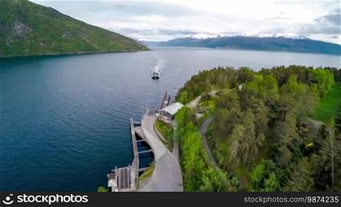 Ferries cross. Aerial footage of beautiful nature in Norway. Flying over the lakes and fjords. View from a bird's-eye view.