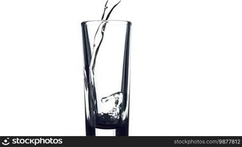 Filling a glass of colored liquid on a white background.