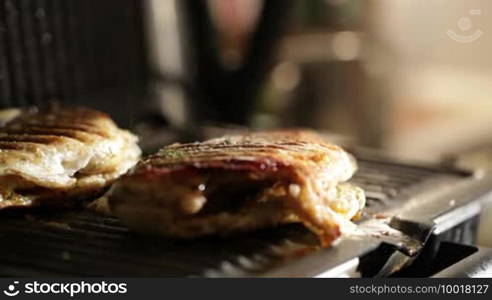 Fish is ready. Adding spices to fish on the grill. Macro shot.