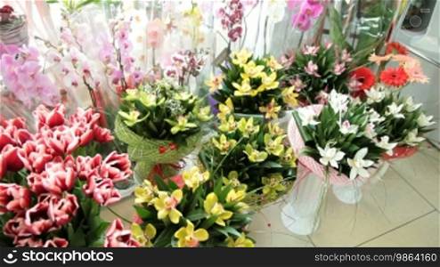 Fresh Cut Bouquets Tulips and Orchids In Flower Shop, Pan Shot