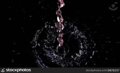 Fresh strawberries splashing on water on black background. Healthy eating concept. Fresh fruits background. Slow motion footage.