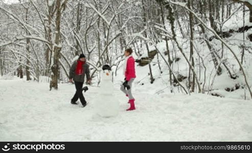 Funny Teenage Couple Enjoying in Snow and Winter