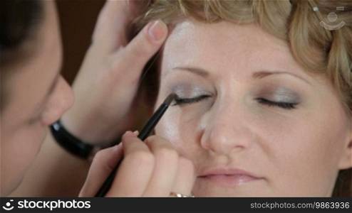 Girl having makeup applied