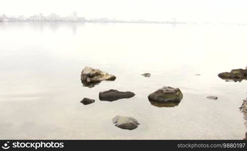 Girl throwing pebble in the water