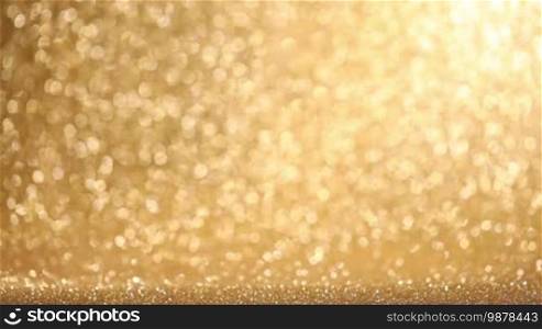 Golden glitter glowing lights Christmas abstract background