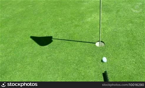 Golf ball is shot in the hole with a kind of a billiard hit, creative, innovation, different