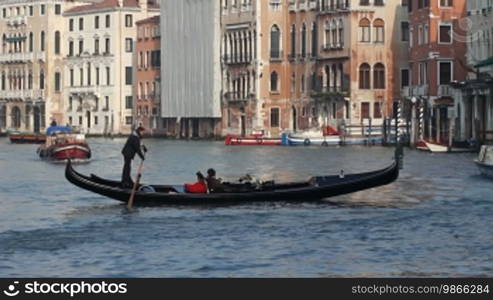 Gondola ride on a canal and house facades in Venice