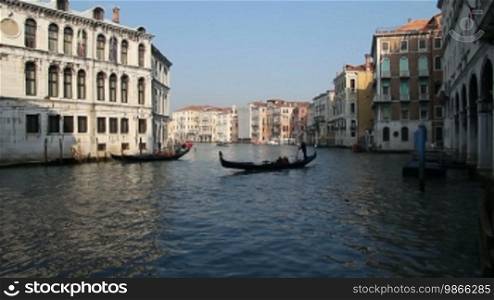 Gondola ride on a canal and house facades in Venice