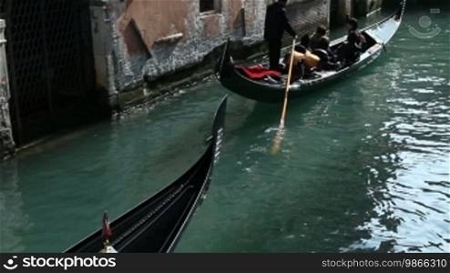 Gondola ride on a canal and house facades in Venice
