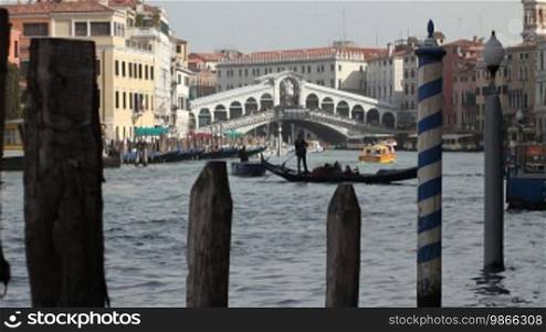Gondolas and boats in front of the Rialto Bridge in Venice