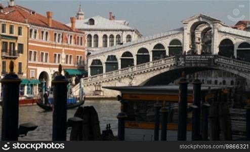 Gondolas and boats in front of the Rialto Bridge in Venice