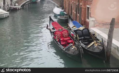 Gondolas in Venice at the pier at the channel